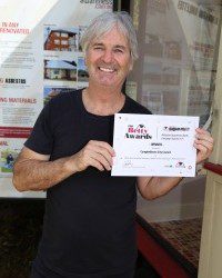 Well done: Actor John Jarratt, who is an ambassador for Asbestos Awareness Month Campaign, with the award for Campbelltown City Council.