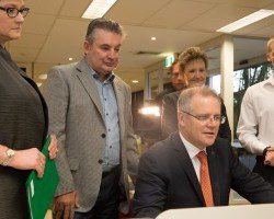 Digital overhaul: Scott Morrison, sitting, Russell Matheson and Marise Payne looking on along with Centrelink Campbelltown staff.