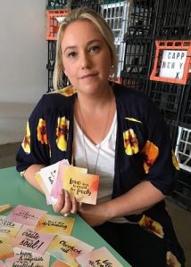 Janelle Lorenzini with some of the cards in her positive affirmation card range which are a reflection of her own journey from struggle to happiness.