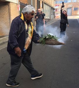 Uncle Ivan walks the length of Anzac Lane while conducting a smoking or cleansing ceremony.