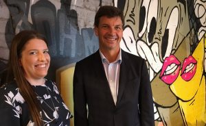Sydneysider's general manager Kaitlyn Daley and MP Angus Taylor in front of a Melbourne cafe laneways inspired wall inside the new restaurant in Camden.