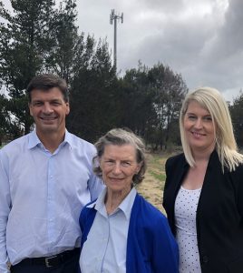 Hume MP Angus Taylor, Telstra’s Lisa McTiernan (right) and Buxton resident Frances Taylor (left) welcome the switch on of a mobile phone tower [in the background] at Buxton.
