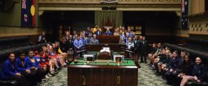 Campbelltown students and school staff have their photo taken on the floor of the lower house of State parliament.