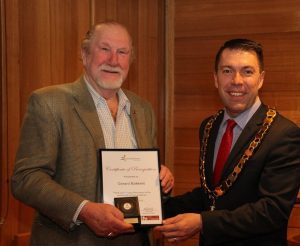 Gerard Bakkers receives his Jubilee Awards certificate from mayor George Brticevic.