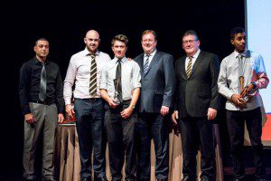 Wests Tigers legend Liam Fulton, NSWRL CEO David Trodden and Wests Tigers recruitment manager Warren McDonnell congratulate U15 Development Rugby League Coaches Award winner Cameron Oitmann.