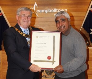 Uncle Ivan Wellington receiving a community service award from Mayor Paul Lake in 2015.
