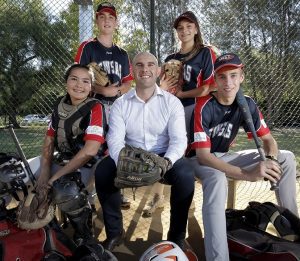 Elderton Homes general manager John Castellano with four members of the South West Sydney Academy of Sport 2018 softball squad.