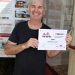 Well done: Actor John Jarratt, who is an ambassador for Asbestos Awareness Month Campaign, with the award for Campbelltown City Council.