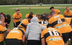 Camden Rams rugby club's first grade in a huddle a half time.
