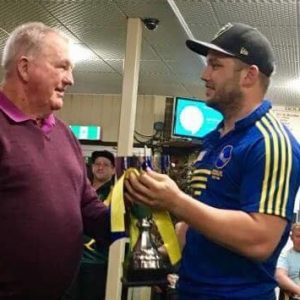 Ray Corkery presents victorious Campbelltown City captain Kurt Austin with the Corkery-Andrews Cup on Saturday night 