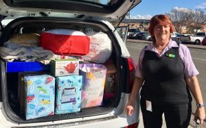 Catherine Chopping from Macarthur Homelessness Steering Committee collects some of the donated items at the halfway point of the drive for household items.