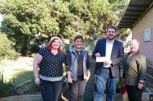 Cr Ben Moroney and local Greens membership officer Sophie Callard, left, present a cheque for $700 to representatives of the WILMA Women’s Health Centre in Campbelltown.