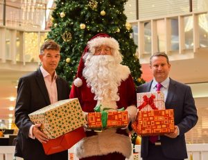 Greg Warren with Macarthur Square centre manager Trevor Hill and Santa. 