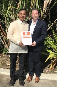 MP Greg Warren presents Dr Jimmy Lopez with an award 
