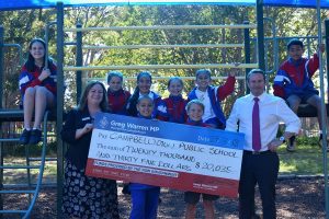 MP Greg Warren with Campbelltown Public School Principal Anna Butler and students celebrating their newly upgraded playground.