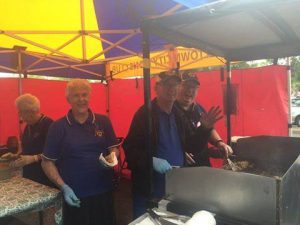 A Campbelltown Lions club crew hard at work around the barbie.