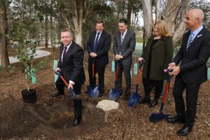 planning minister Anthony Roberts planting the 6,000th tree at Stockland’s Willowdale estate. With him are Fiona Morrison, NSW commissioner for open space and parklands,  Cr George Brticevic, Mayor of Campbelltown, Richard Rhydderch from Stockland and Camden MP Chris Patterson.