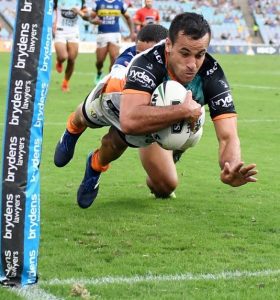 Corey Thompson goes over for one of his two tries against the Eels yesterday to help Wests Tigers to a 30-20 victory.